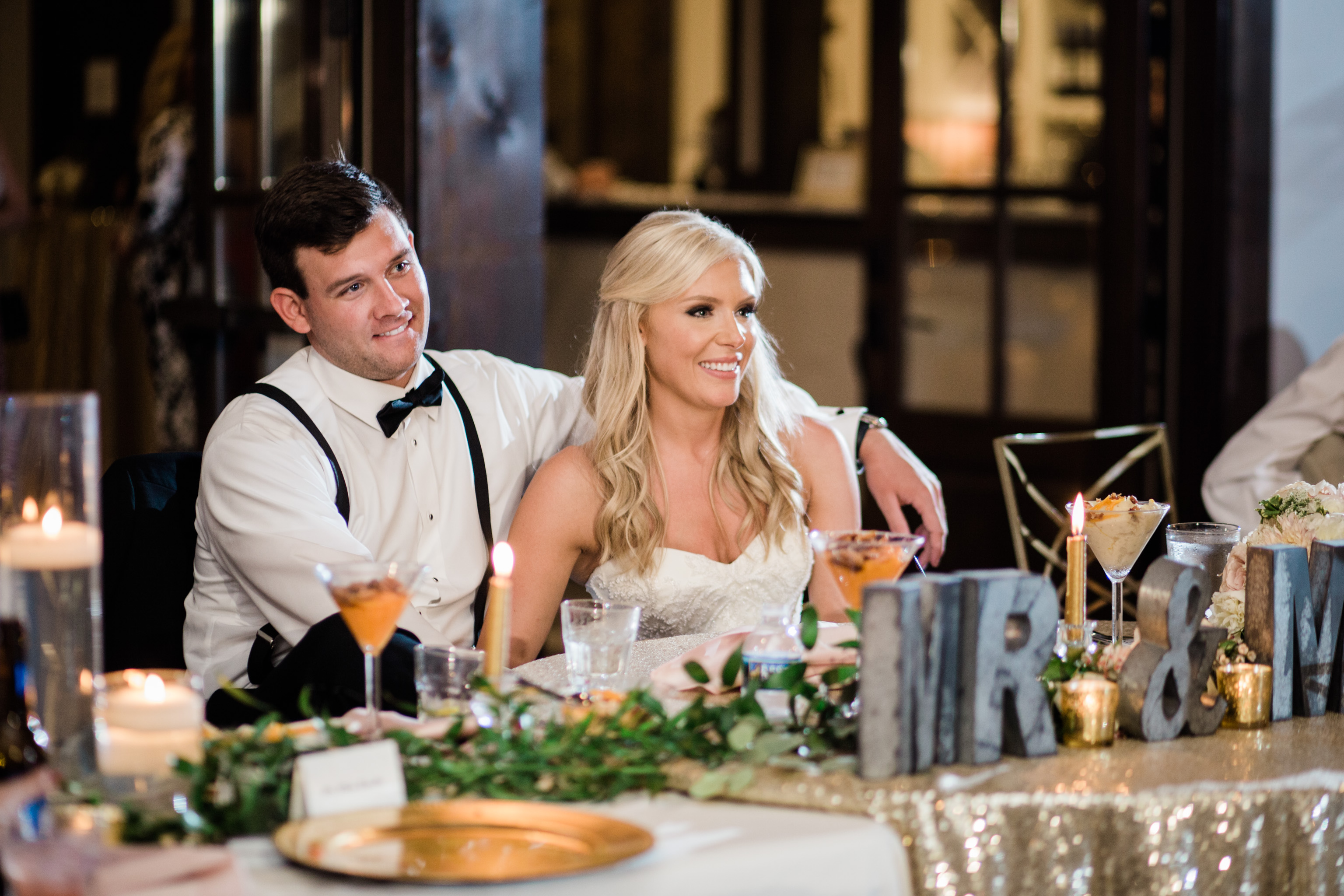 Bride and groom enjoy listening to toasts during their reception at Foxhall's Legacy Lookout. Photo by Rebecca Cerasani, Atlanta's premier luxury wedding photographer
