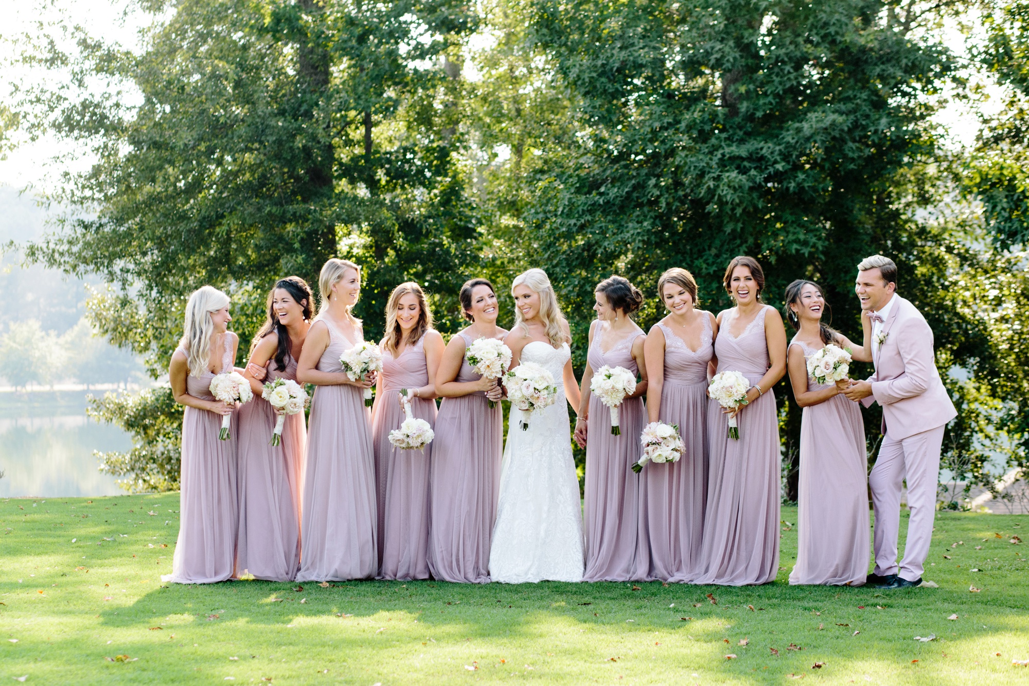 The colors of these bridesmaid dresses complimented Foxhall's rich green landscape so beautifully. Photo by Rebecca Cerasani, Atlanta's luxury destination wedding photographer.