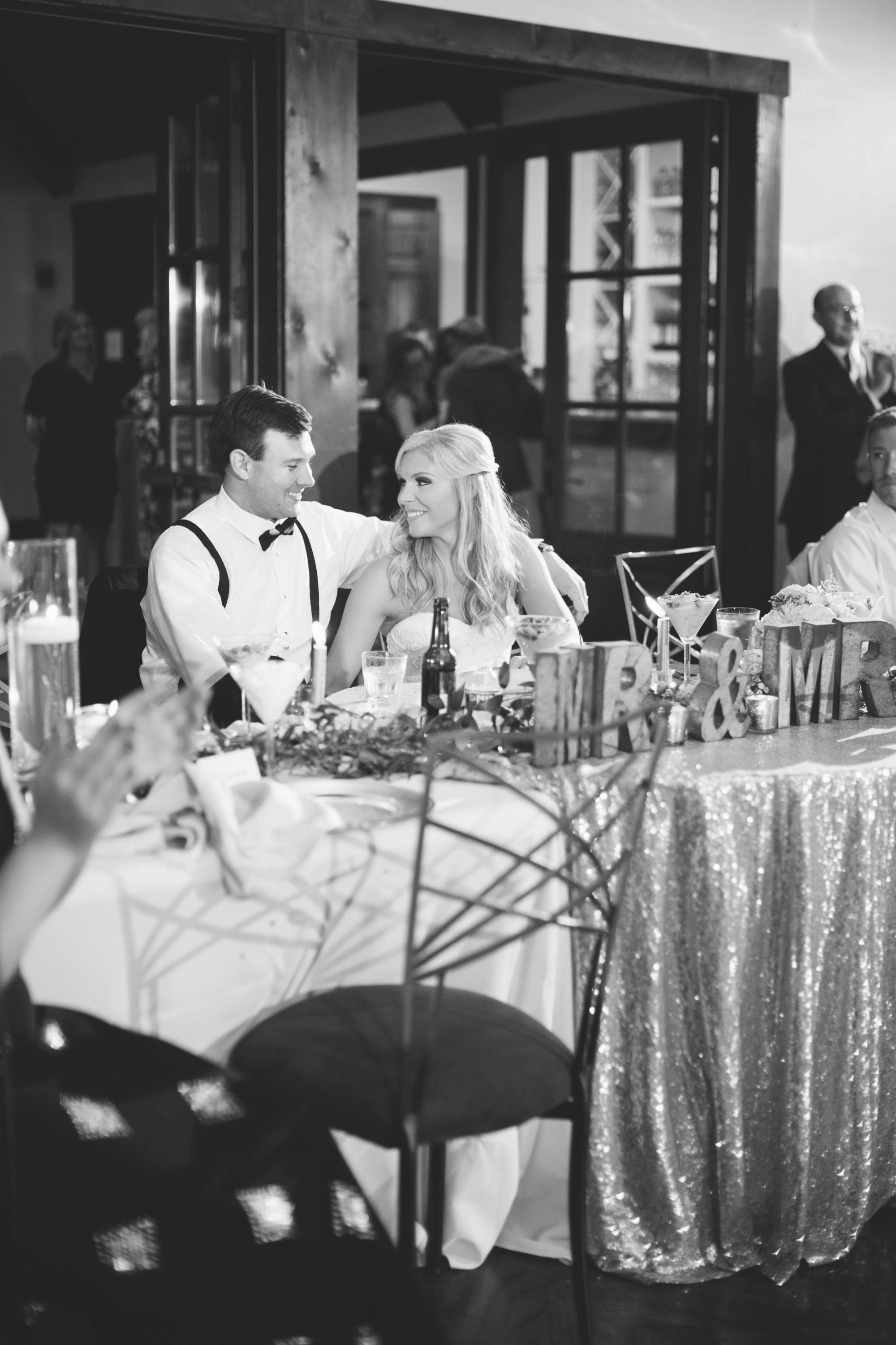 Bride and groom enjoy listening to toasts during their reception at Foxhall's Legacy Lookout. Photo by Rebecca Cerasani, Atlanta's premier luxury wedding phtoographer