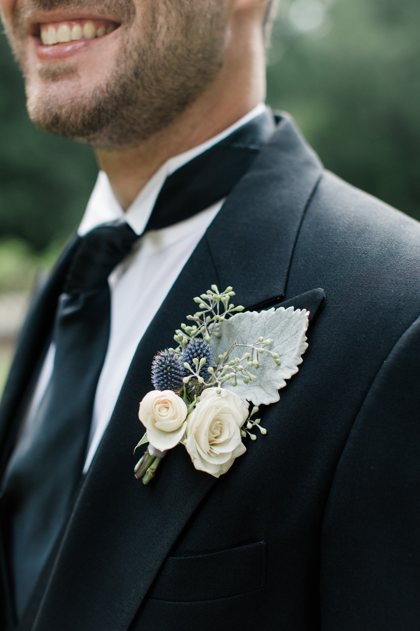 Delicate details are brought together in this groom boutonniere captured by Rebecca Cerasani