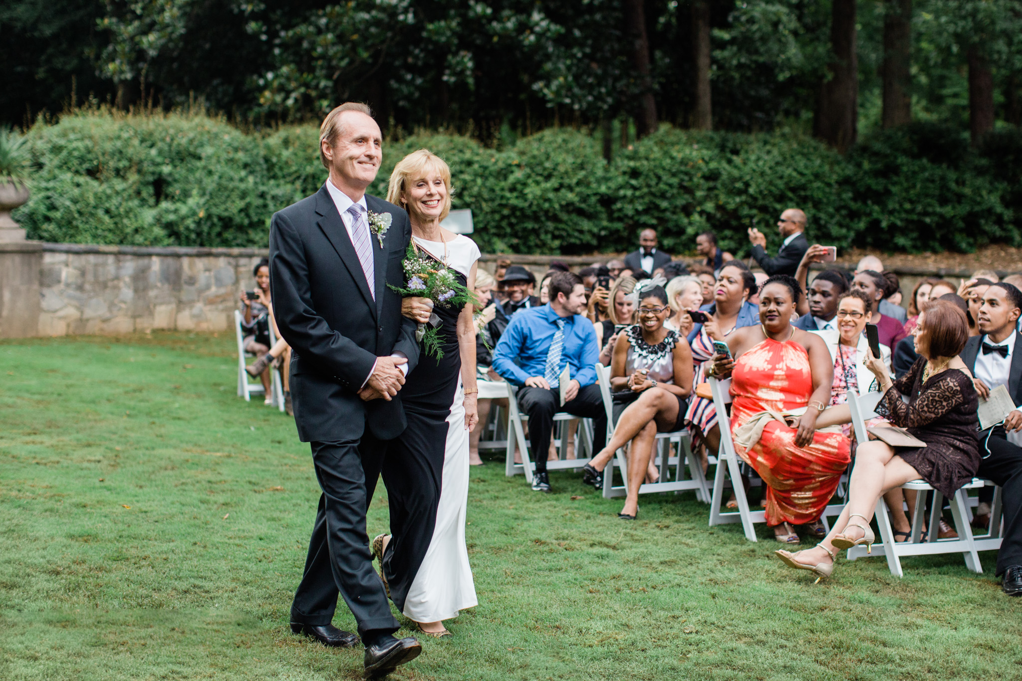 Parents of the groom start wedding processional. Photo by Rebecca Cerasani Weddings.