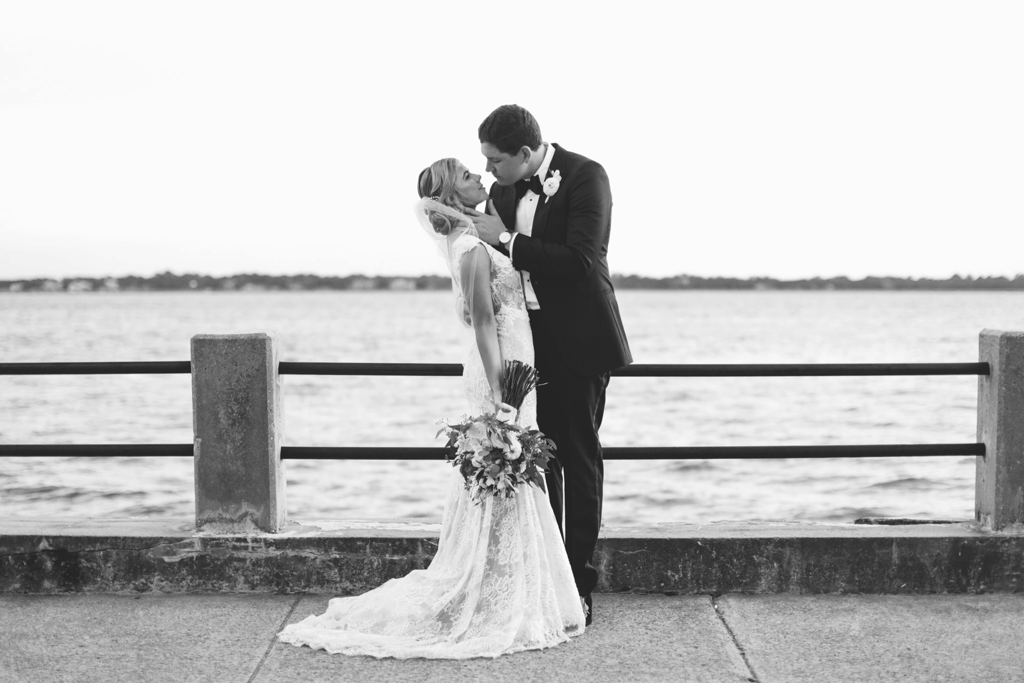 This bride and groom share an intimate moment as husband and wife along the water. Photo by destination photographer Rebecca Cerasani