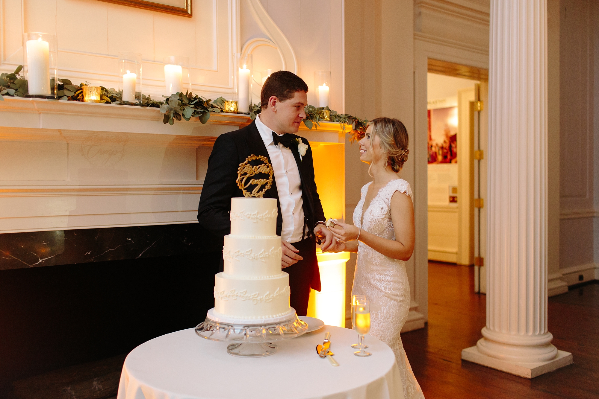 Bride and groom cake cutting at a classy and Elegant reception at the Old Exchange and Provost Dungeon. Historic Downtown Charleston, SC Wedding by top ranked photographers Leigh and Becca.