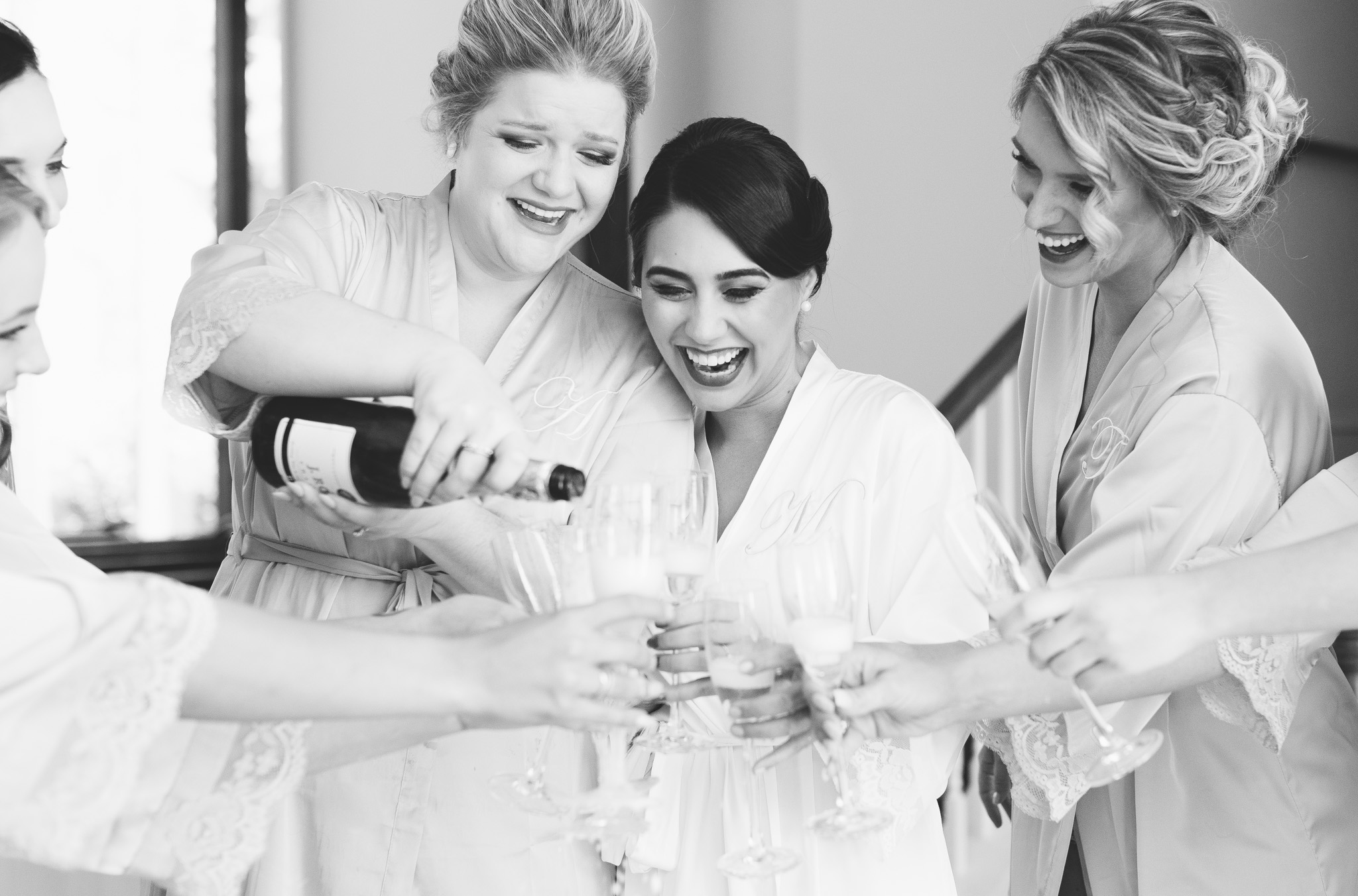 Nothing better than a toast with friends to celebrate your wedding day! Capture by Rebecca Cerasani, luxury wedding photographer.