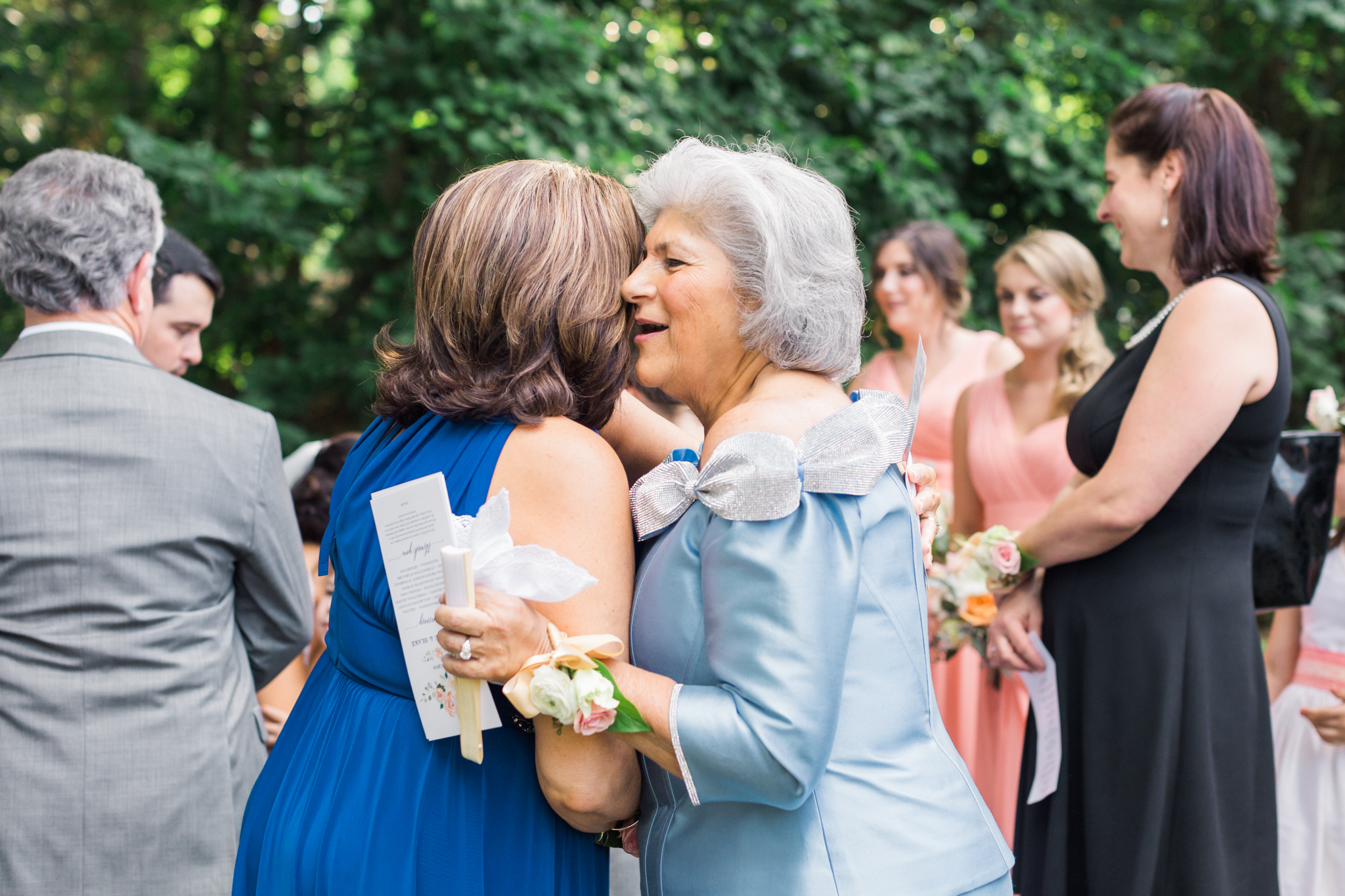Mothers of the bride and groom hugging after the wedding ceremony!