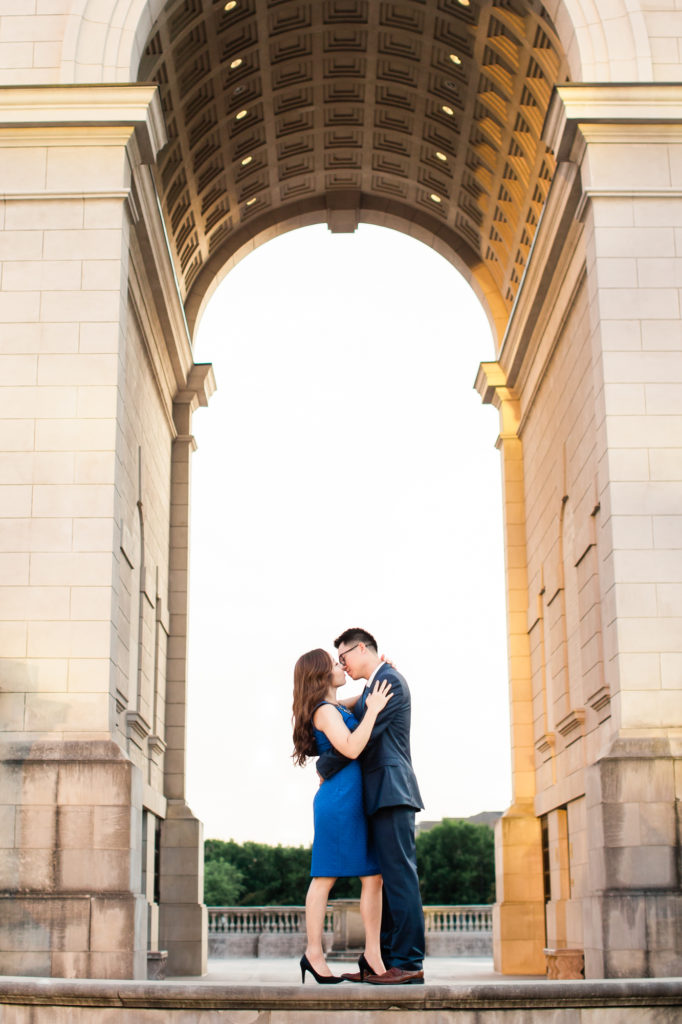 Bride and groom to be kiss under the Millennium Gate Museum