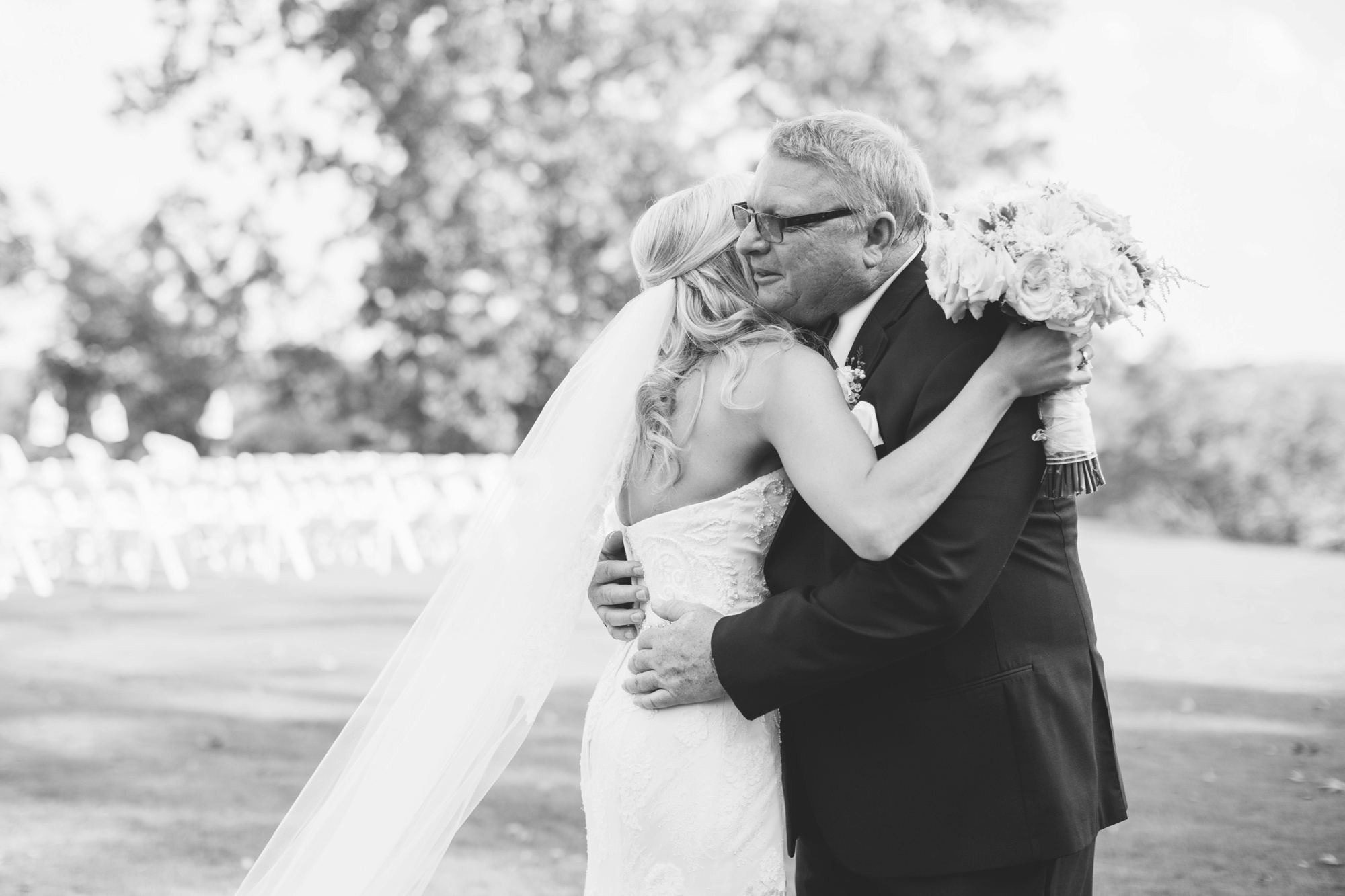 Bride's dad holds on tight to his daughter moments before giving her away. Photo by luxury wedding photographer Rebecca Cerasani