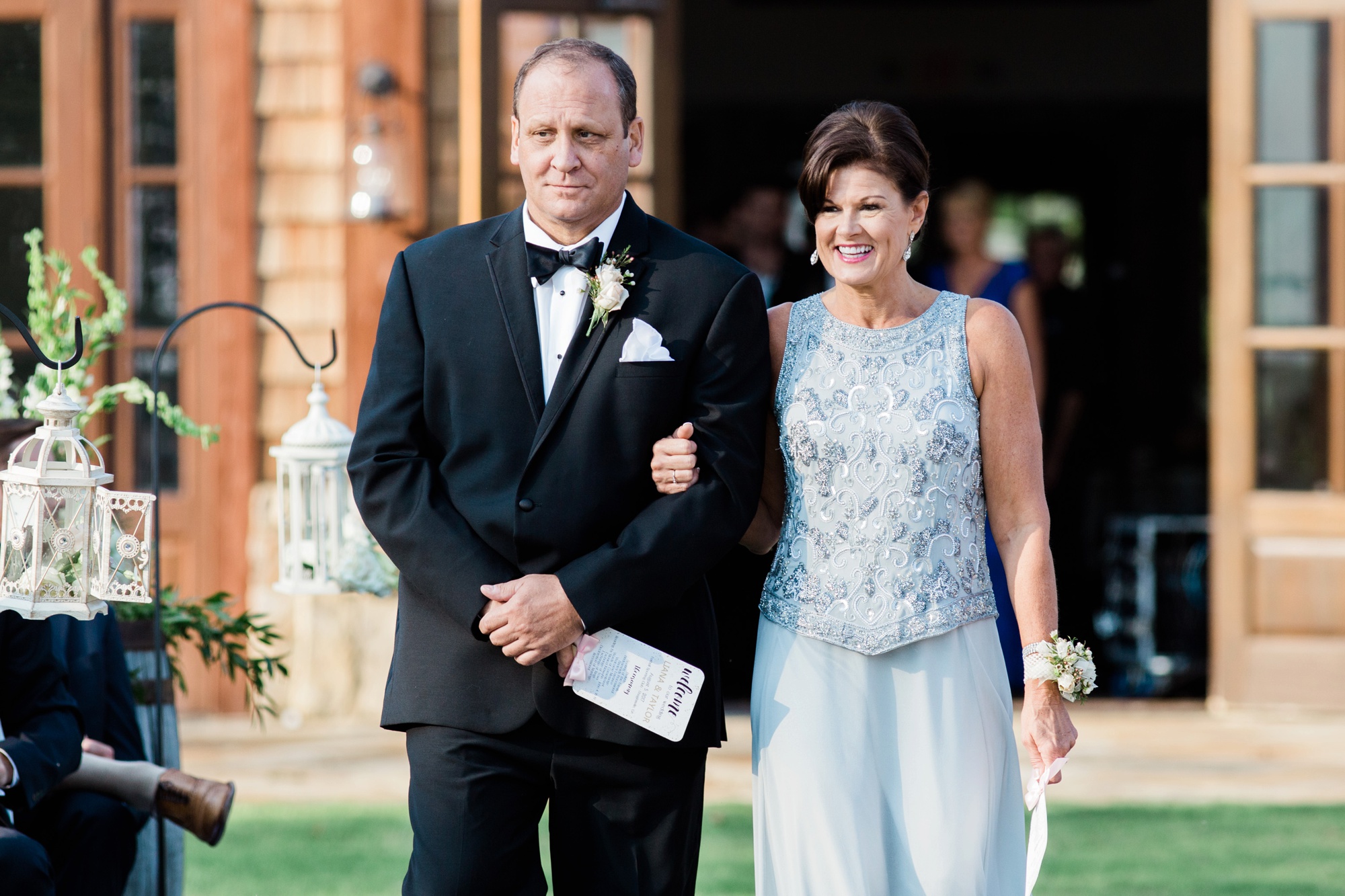 Parents of the groom walk down the aisle in these wedding pictures from Foxhall Sporting Club by Rebecca Cerasani, Luxury wedding photographer