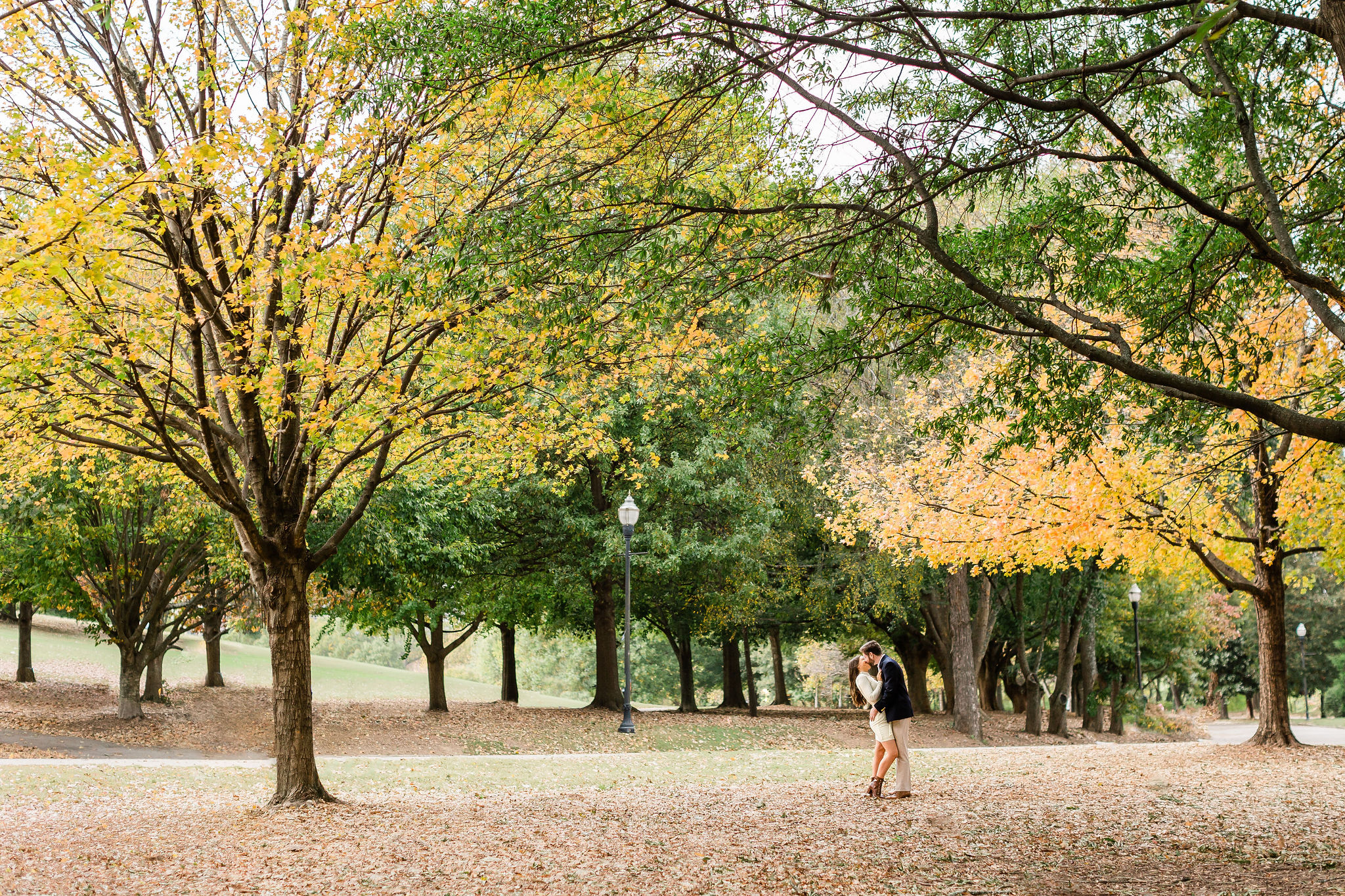 fall leaves surround romantic couple in Piedmont park