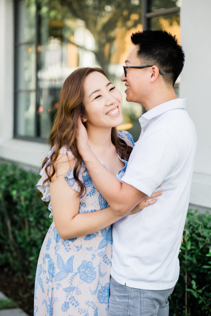 Engaged couple laughs during photoshoot at Westside Provisions District